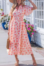 Charming puff sleeve midi dress in white with pink polka dots, smocked waist, and pockets.
