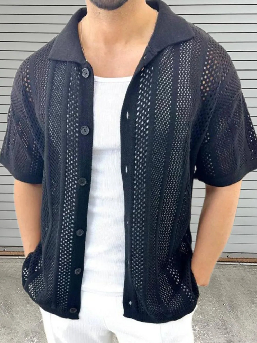 Black open-knit resort shirt with short sleeves and a collared neckline.