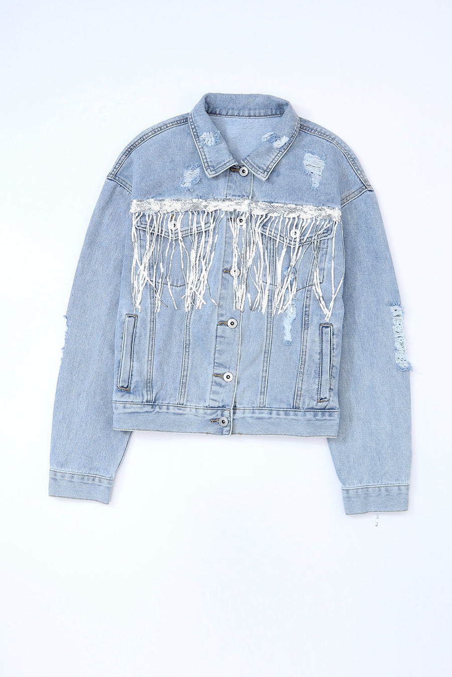 Medium wash denim trucker jacket with distressed details and white fringe accents.