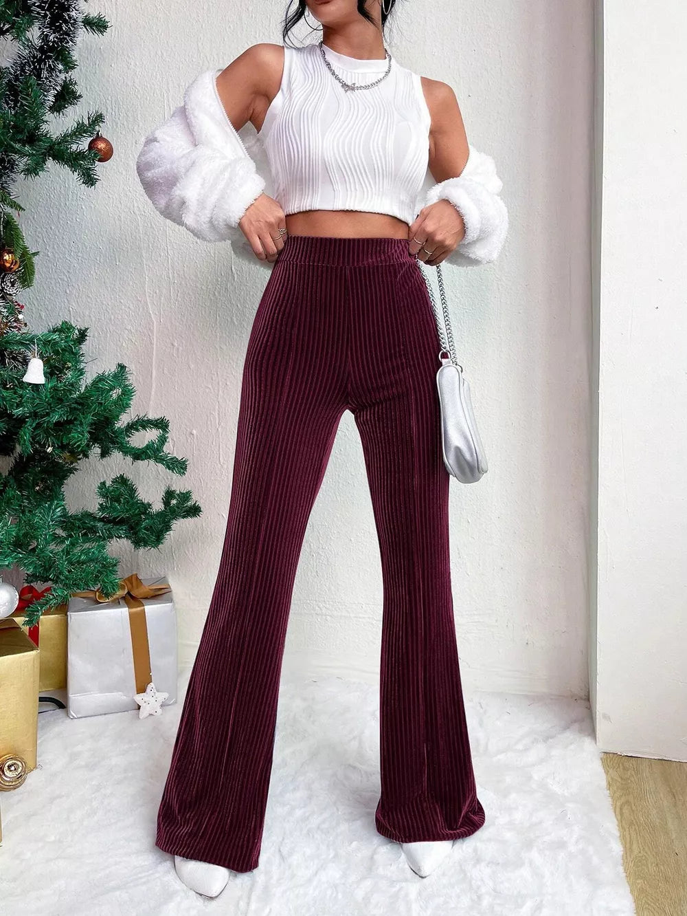 Burgundy corduroy high-waist flare maternity pants with vertical ribbing.