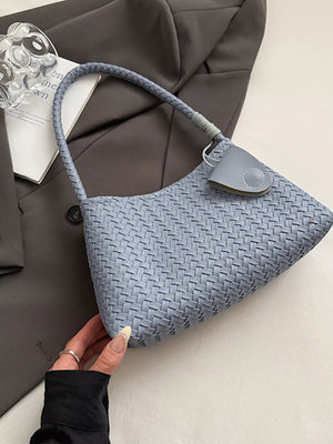 Blue woven shoulder bag with braided strap and leather tab detail