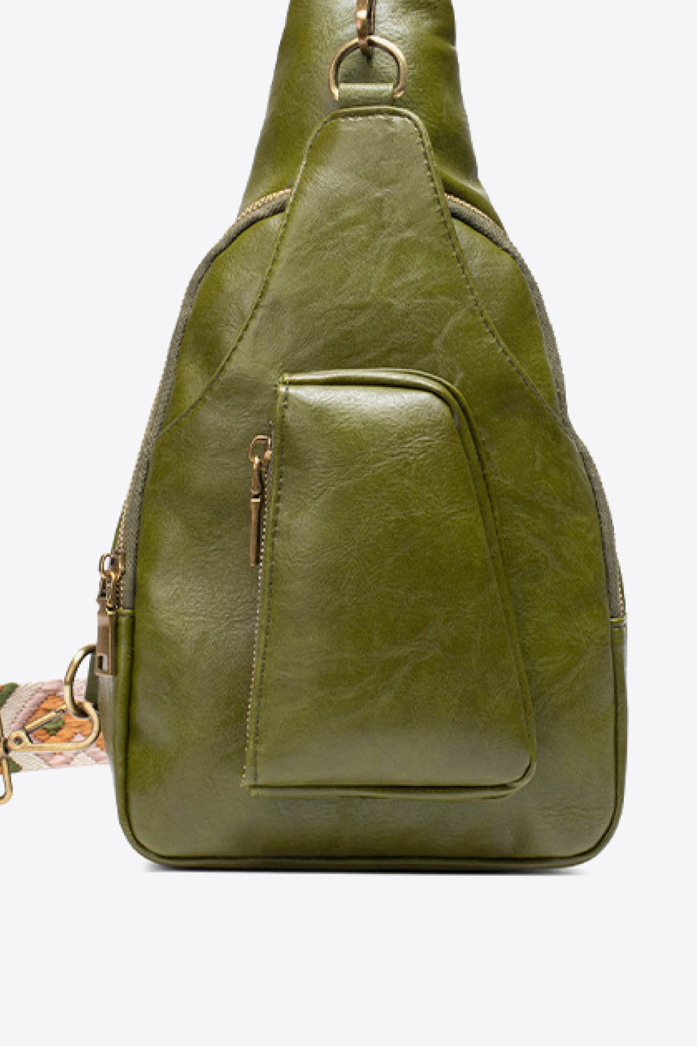 Green textured sling bag with woven strap detail and front zip pocket.