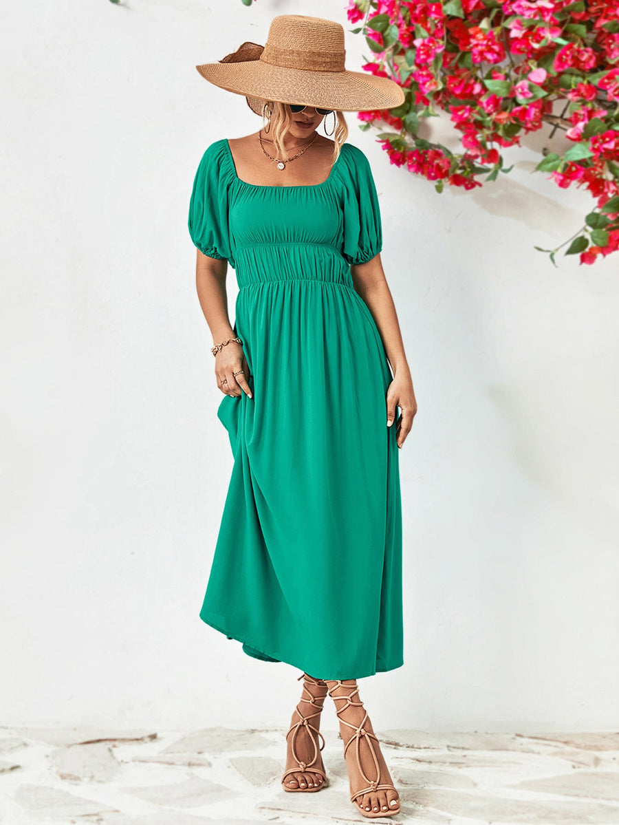 Green midi dress with gathered bodice, square neckline, puff sleeves, and A-line skirt.