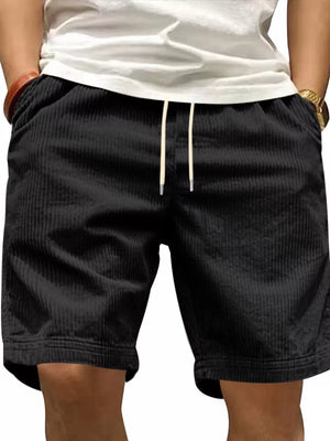 Black corduroy drawstring shorts with white drawstrings and side pockets.