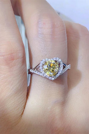 Yellow heart halo moissanite engagement ring in silver with diamond band.