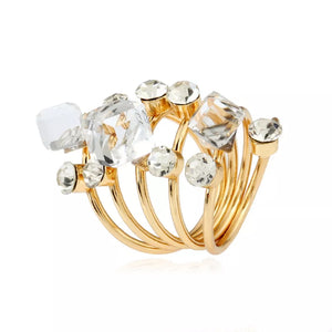 Gold-plated multi-layered ring with clear crystals and square gems.