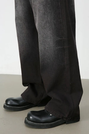 Faded dark wide-leg denim trousers with a relaxed fit.
