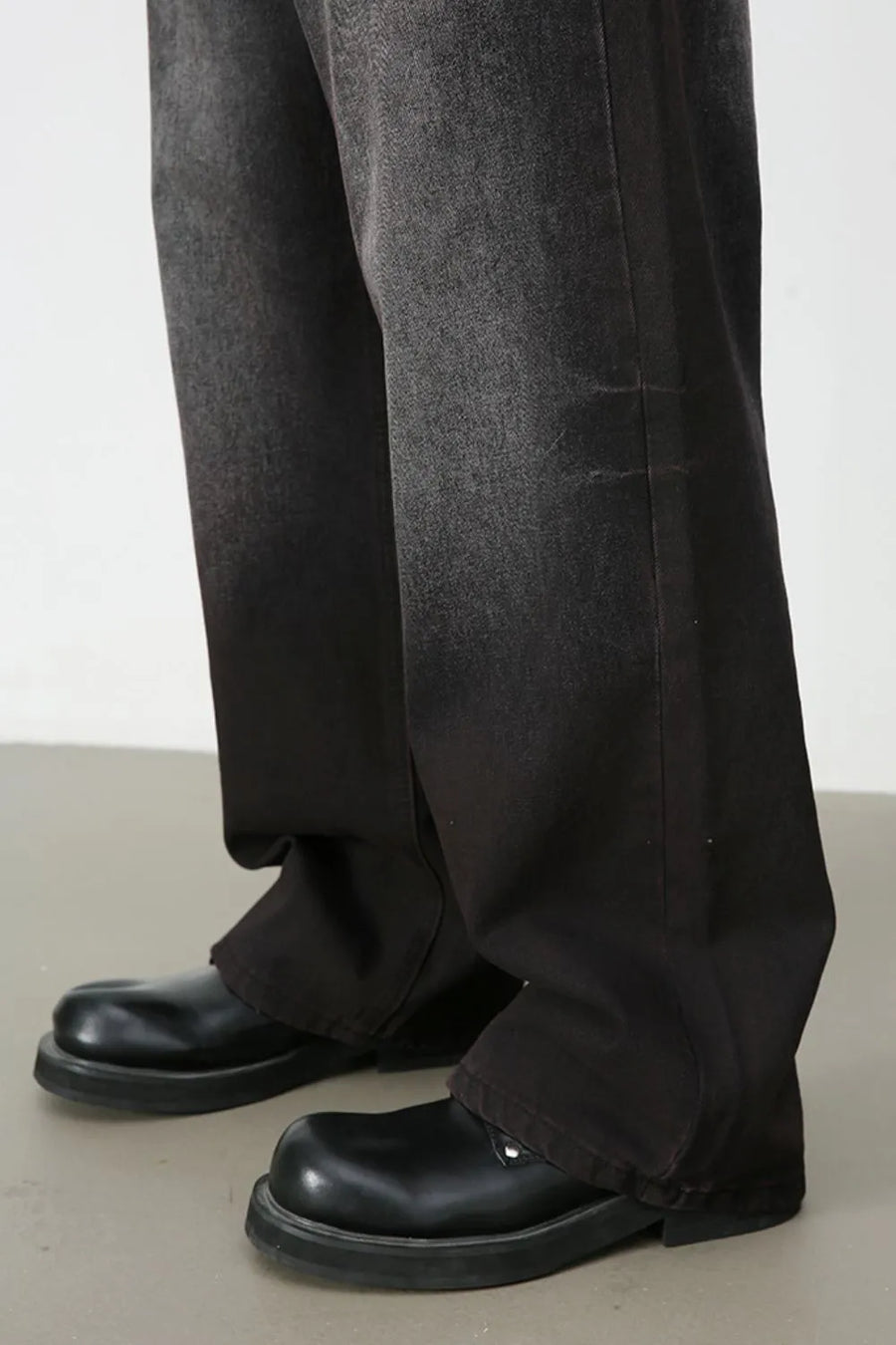 Faded dark wide-leg denim trousers with a relaxed fit.