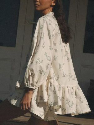 Cream floral print mini dress with ruffled hem and puff sleeves