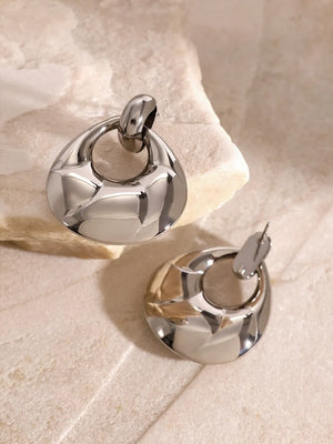 Sculpted gold statement earrings with a textured, polished finish and a chic, modern design.