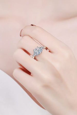 Silver trilogy ring with a large square-cut center stone and two smaller stones.
