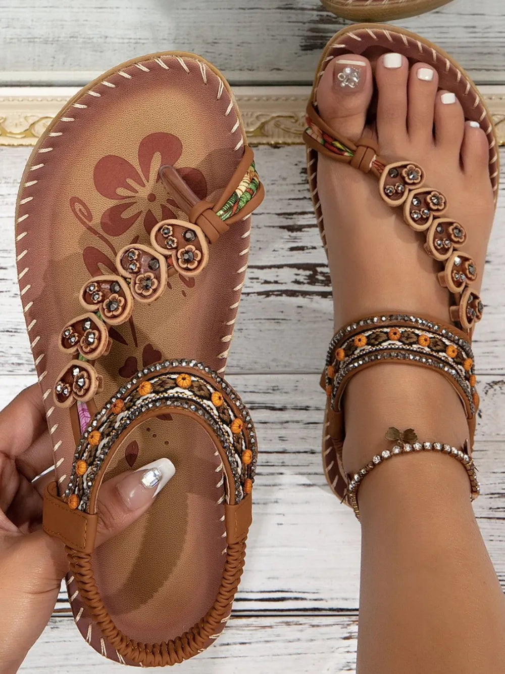 Caramel embellished thong sandals with floral and heart details and beaded ankle straps.
