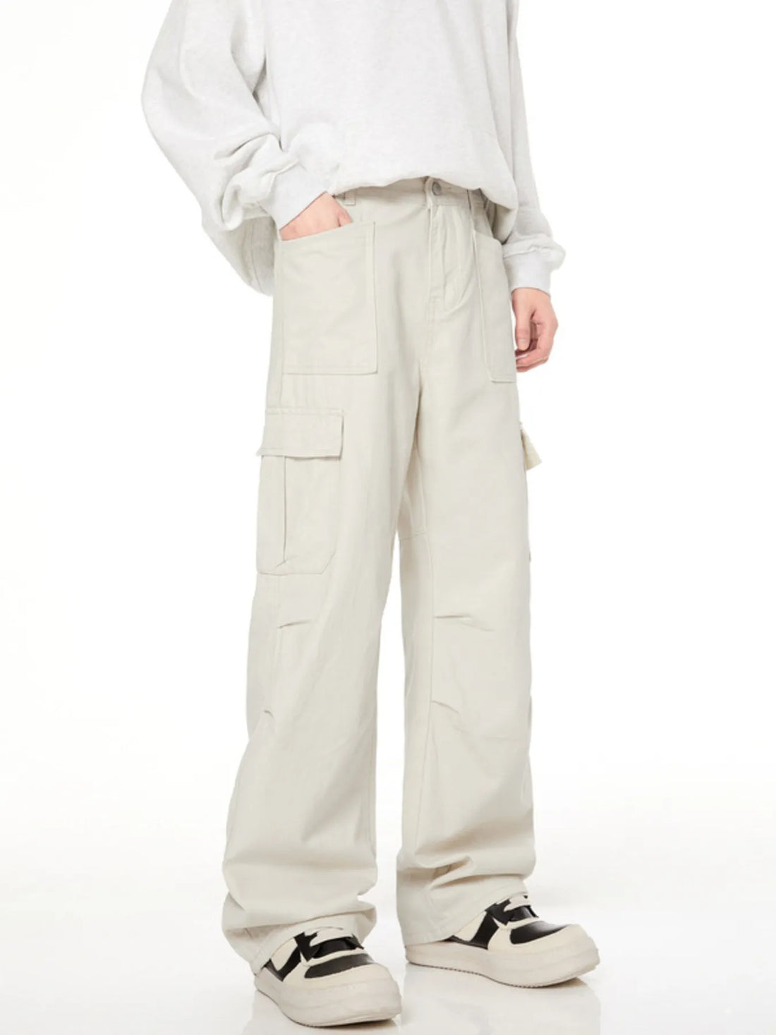 Men's loose fit cargo pants in creamy-white with multiple pockets and a casual style.