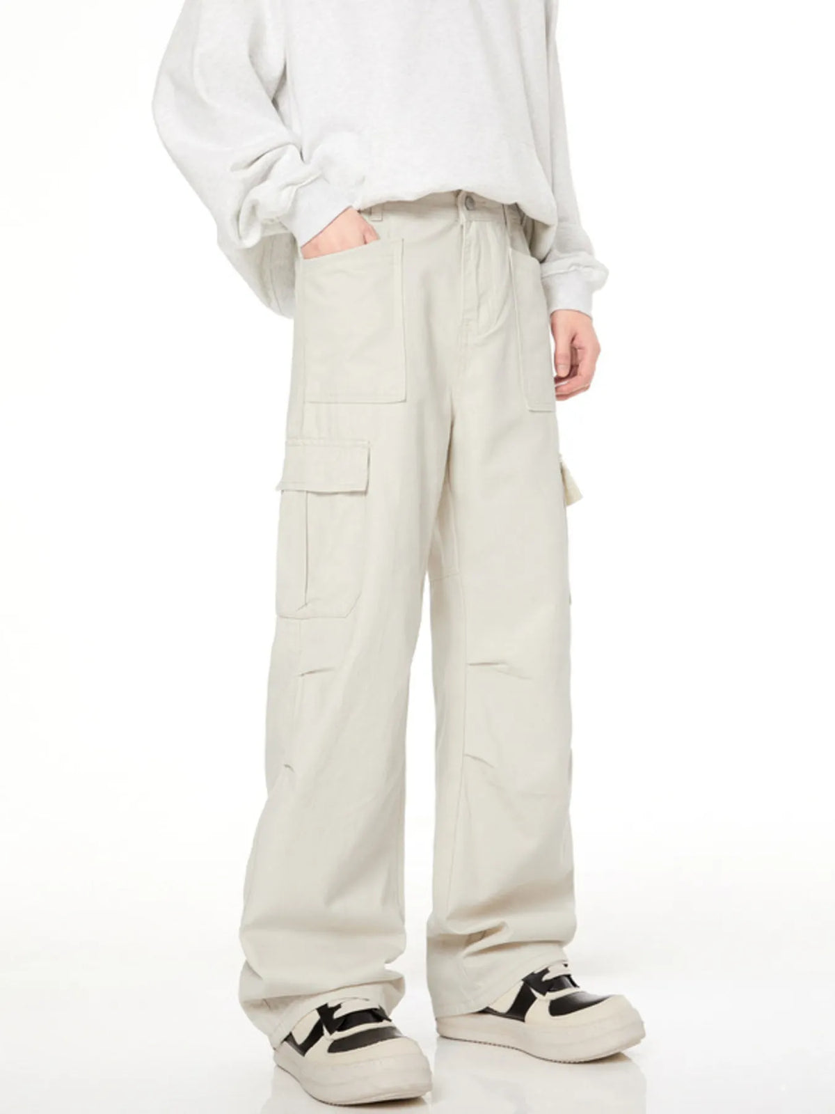 Men's loose fit cargo pants in creamy-white with multiple pockets and a casual style.