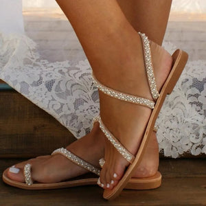 Camel gladiator sandals with pearl embellishments and toe loop.