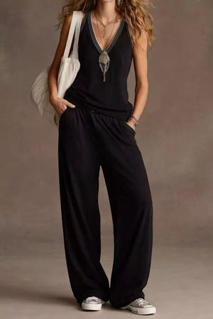 Black V-neck tank top with embellished neckline and wide-leg pants with elastic waist.