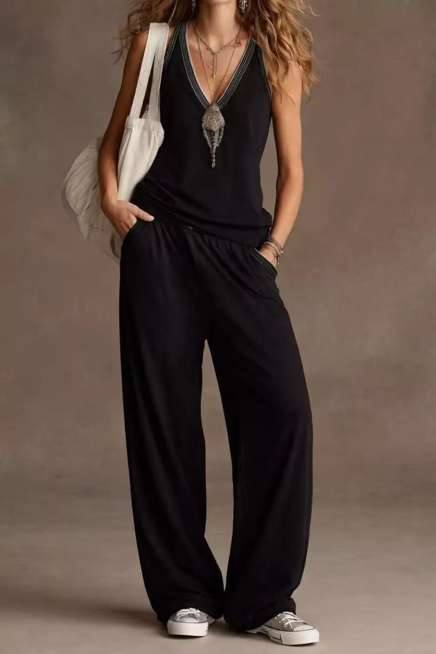 Black V-neck tank top with embellished neckline and wide-leg pants with elastic waist.