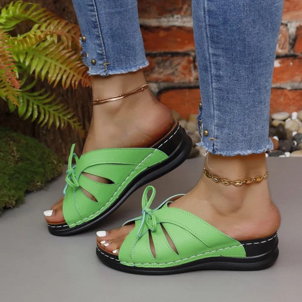 Neon green leather lace-up cutout slides with white stitching and black soles.