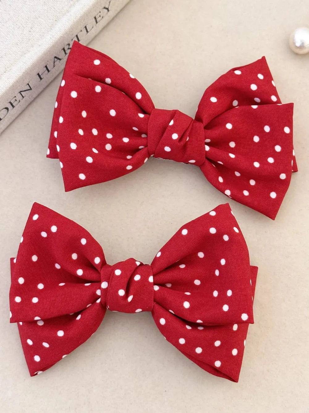 Red polka dot hair bows, a chic accessory set for adults.