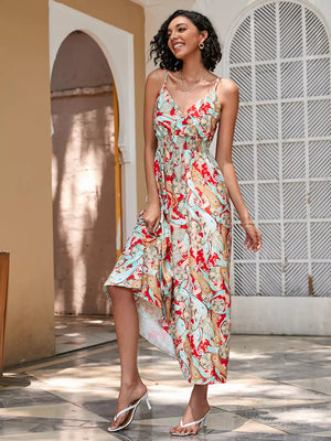 Chic floral midi dress with spaghetti straps and smocked waist in red and blue paisley print.