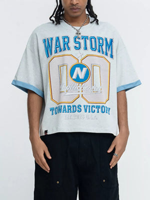 Grey graphic t-shirt with blue contrast trim and "WAR STORM" text.