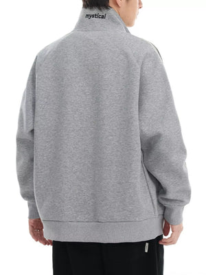 Plus-size grey zip-up sweatshirt with contrast stitching and embroidered text on collar.