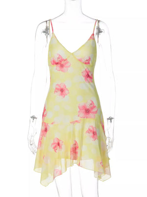 Yellow floral asymmetrical mini dress with ruffled hem and polka dots.