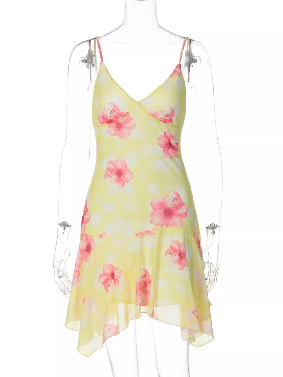 Yellow floral asymmetrical mini dress with ruffled hem and polka dots.