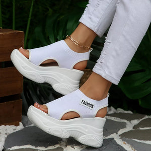 White knit open-toe wedge sandals with chunky sole and "Fashion" detail.