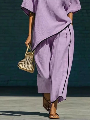 Purple half sleeve two-piece set with contrast trim and wide leg pants.