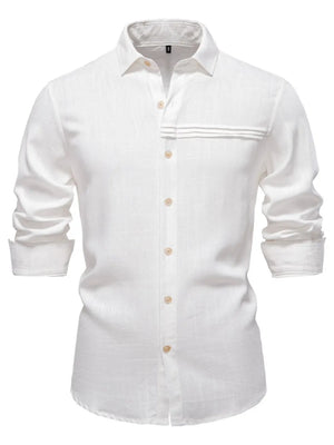White linen button-up shirt with pleated pocket detail and rolled sleeves.