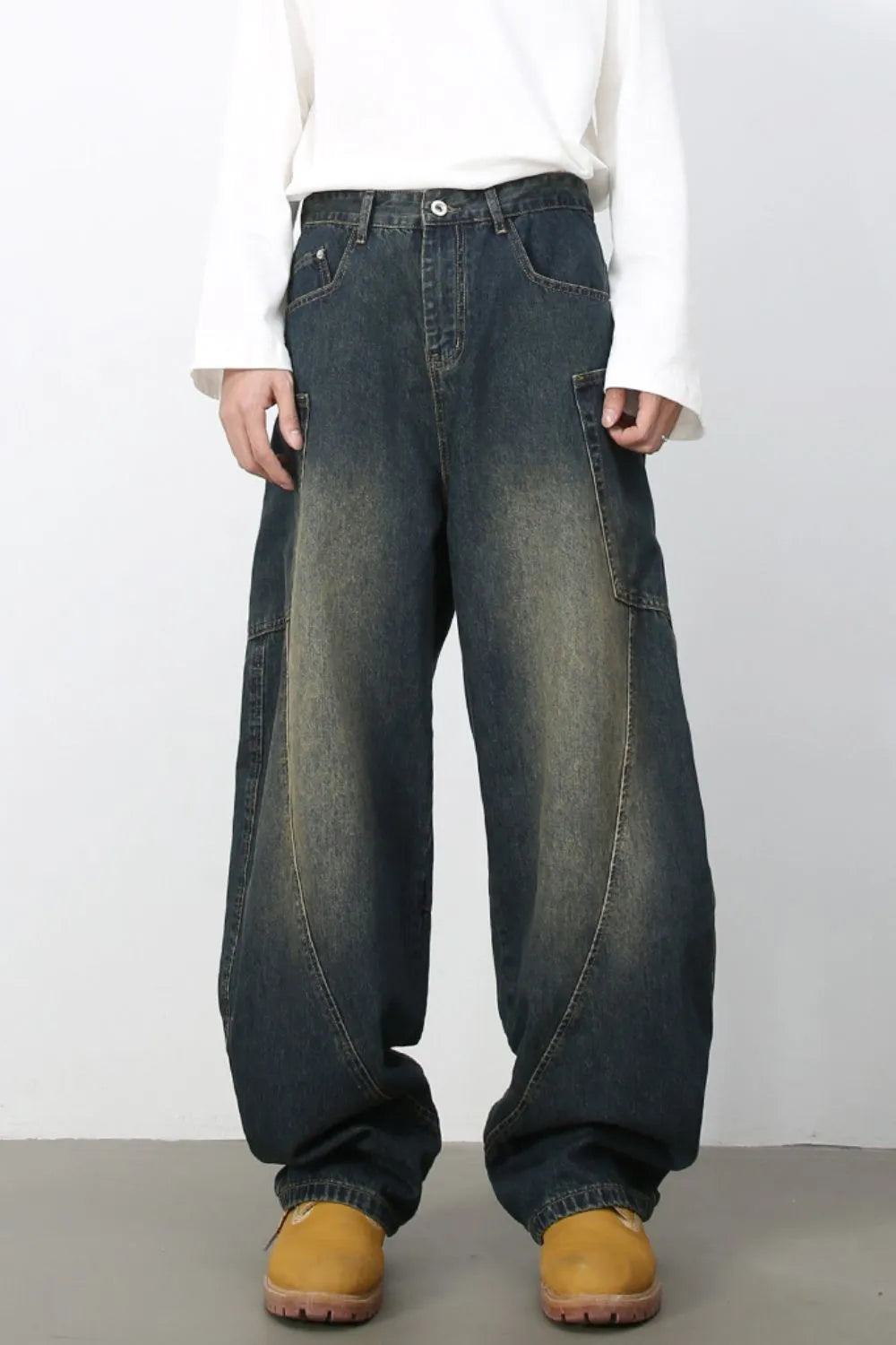 Sculpted denim balloon trousers in dark wash with wide legs and cargo pockets.