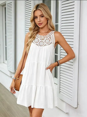 White tiered dress with lace yoke and sleeveless design