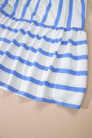 Tiered dress with blue and white stripes, ruffled hem, and ricrac trim.