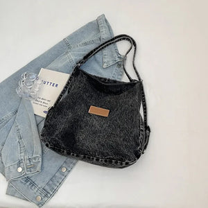 Black denim hobo bag with leatherette patch and shoulder strap