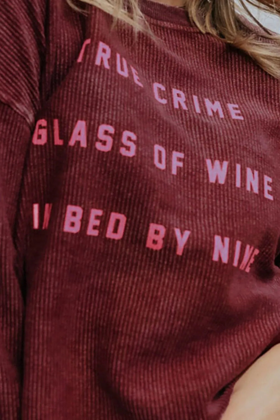 Wine corduroy sweatshirt with "True Crime Glass of Wine Bed by Nine" graphic print.