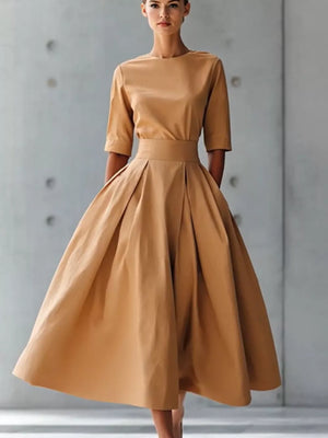 Camel A-line midi dress with pleated skirt, crew neck, and three-quarter sleeves.