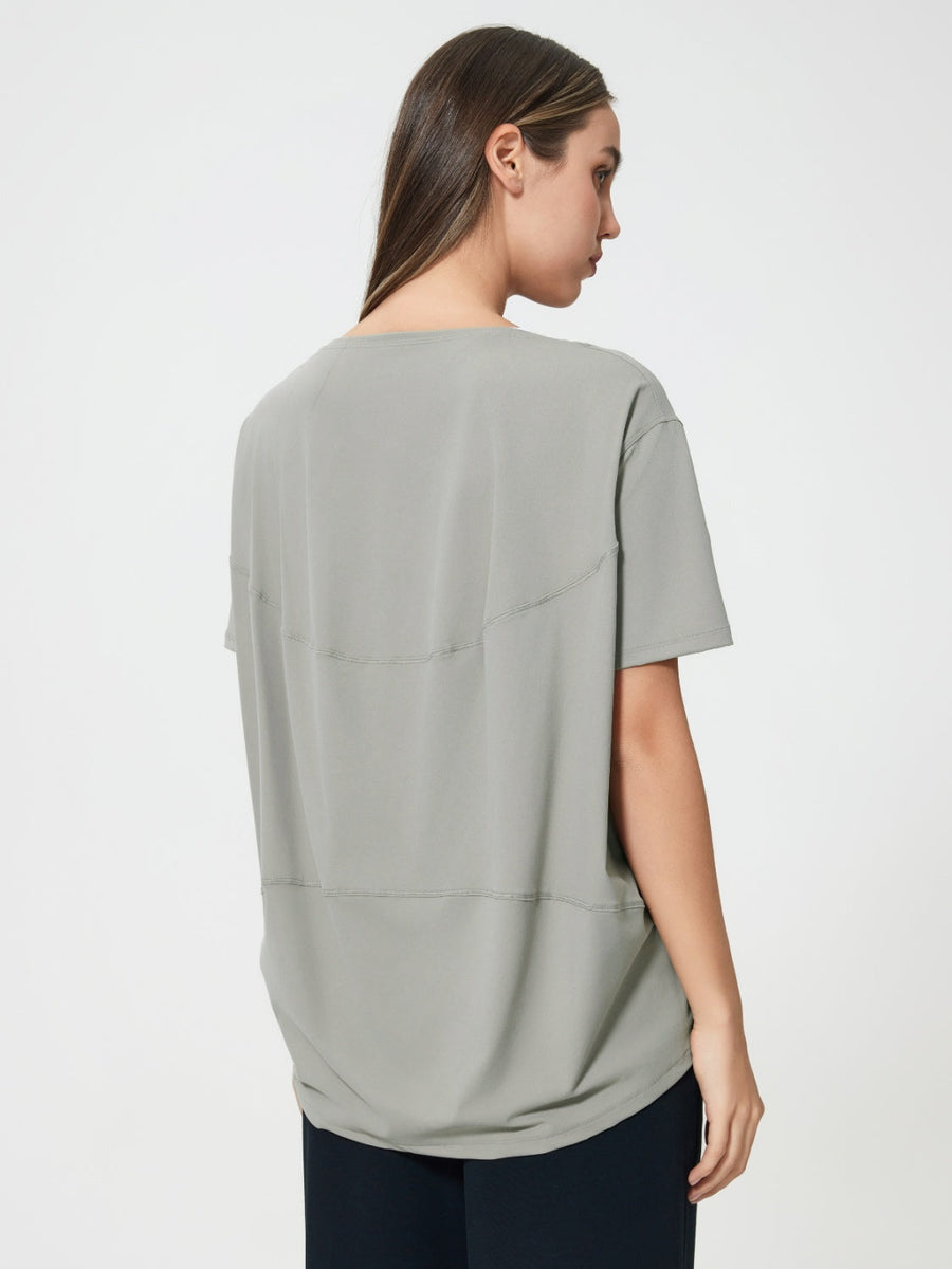 Relaxed fit performance tee in gray with seam details on back.