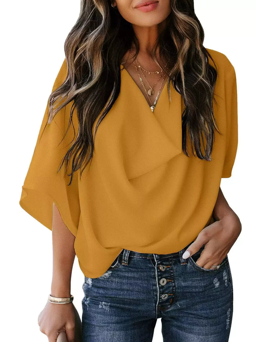 Yellow flowy half sleeve blouse with V-neck and draped front detail.