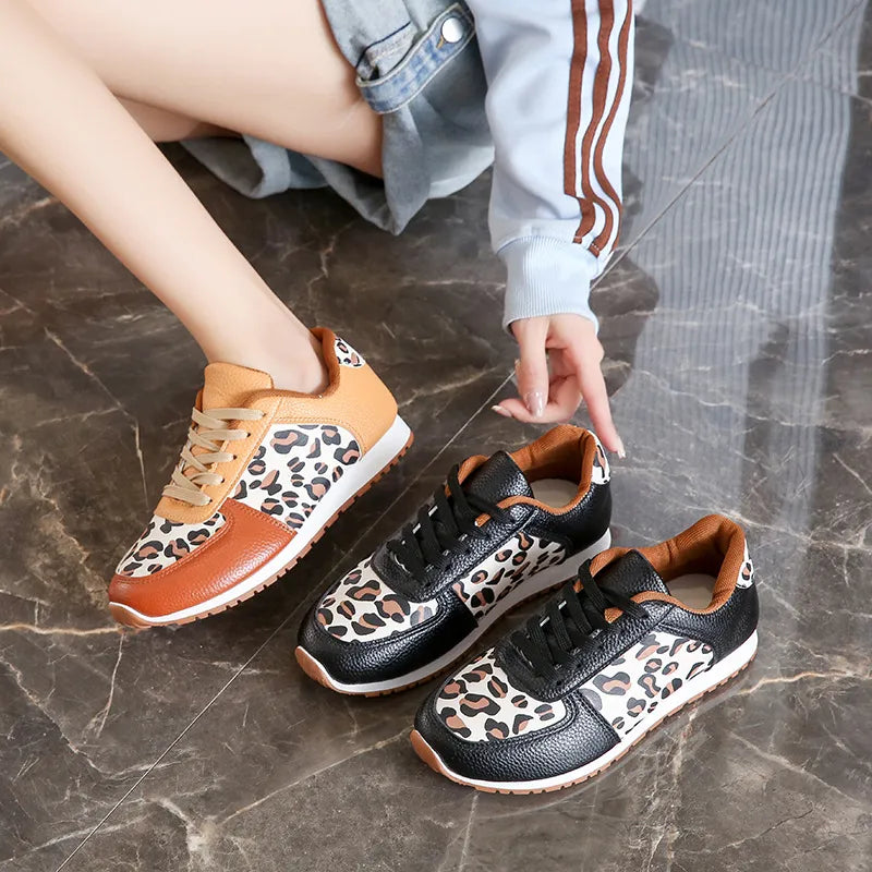 Leopard print panel sneakers in black and caramel with lace-up closure.
