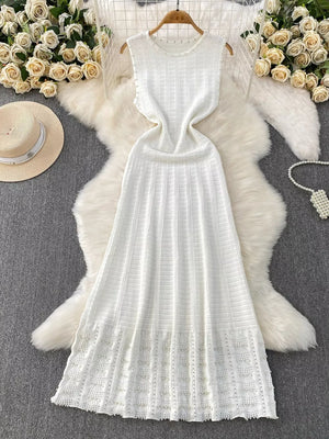White knit midi dress with cutout details and textured pattern.