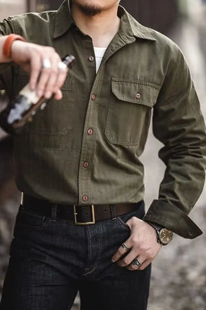 Army green cotton twill utility shirt with two chest pockets and button front.
