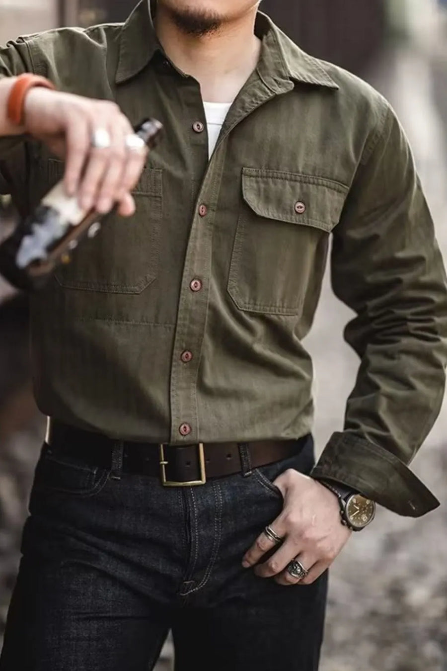 Army green cotton twill utility shirt with two chest pockets and button front.