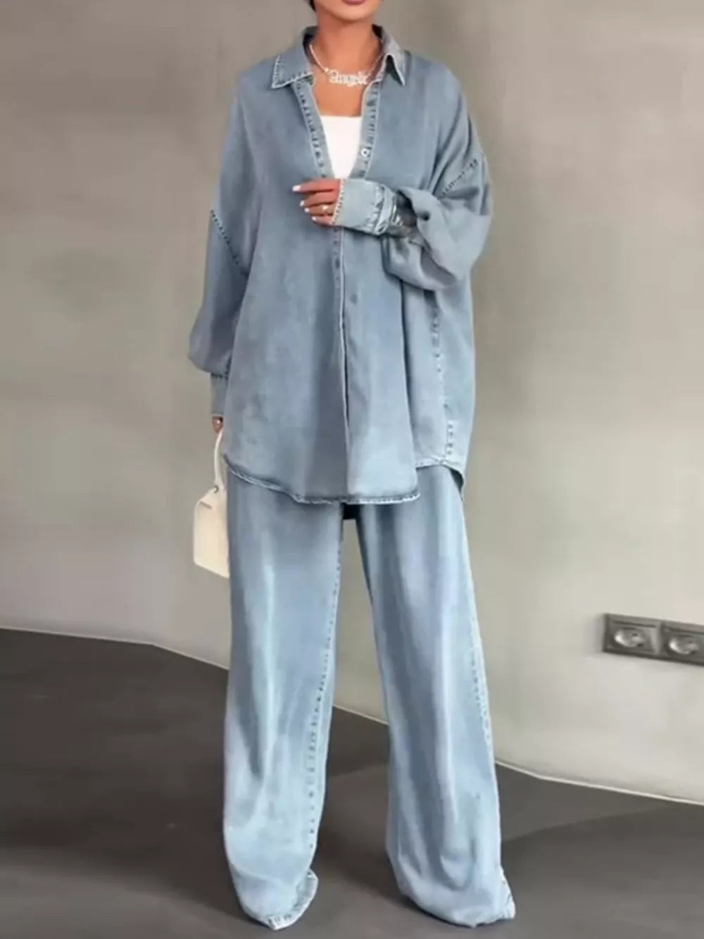 shirt and pants set in light blue featuring buttoned and relaxed fit