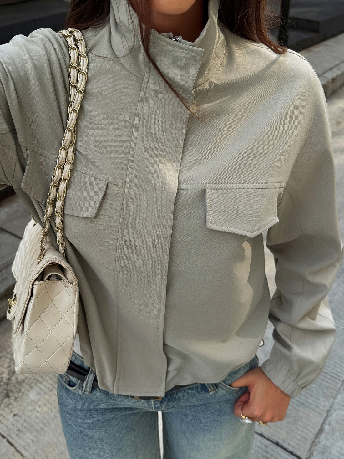 windbreaker in sage green featuring zipper and relaxed fit