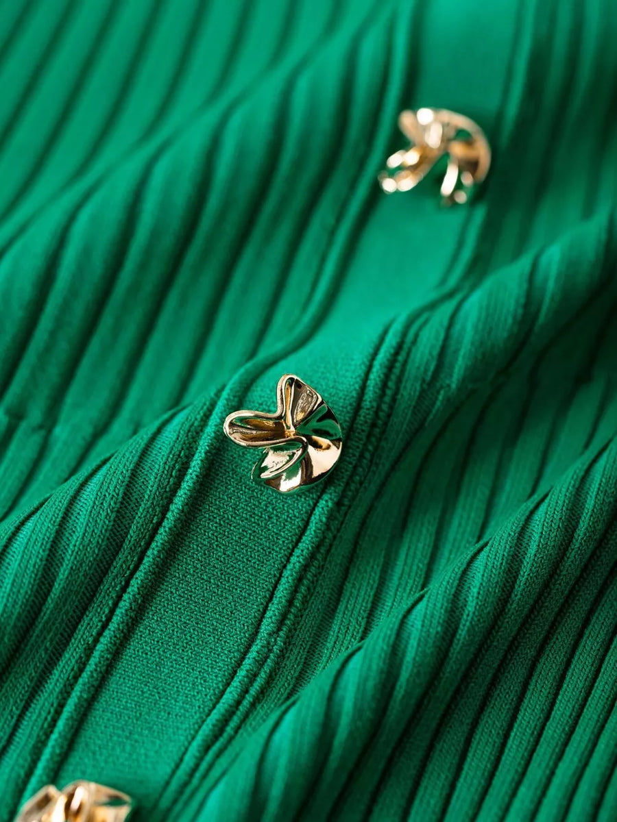 Green knit dress with gold button details and ribbed texture.