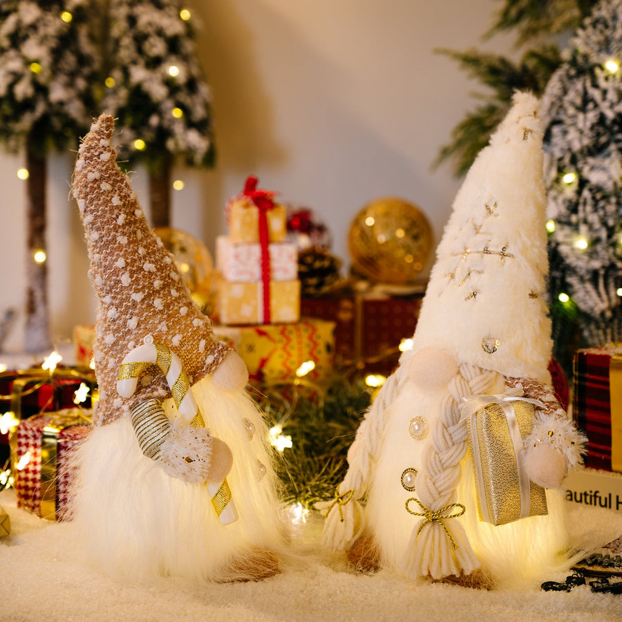 Illuminated festive gnomes, one male with candy cane, one female with gift, battery-operated decor.