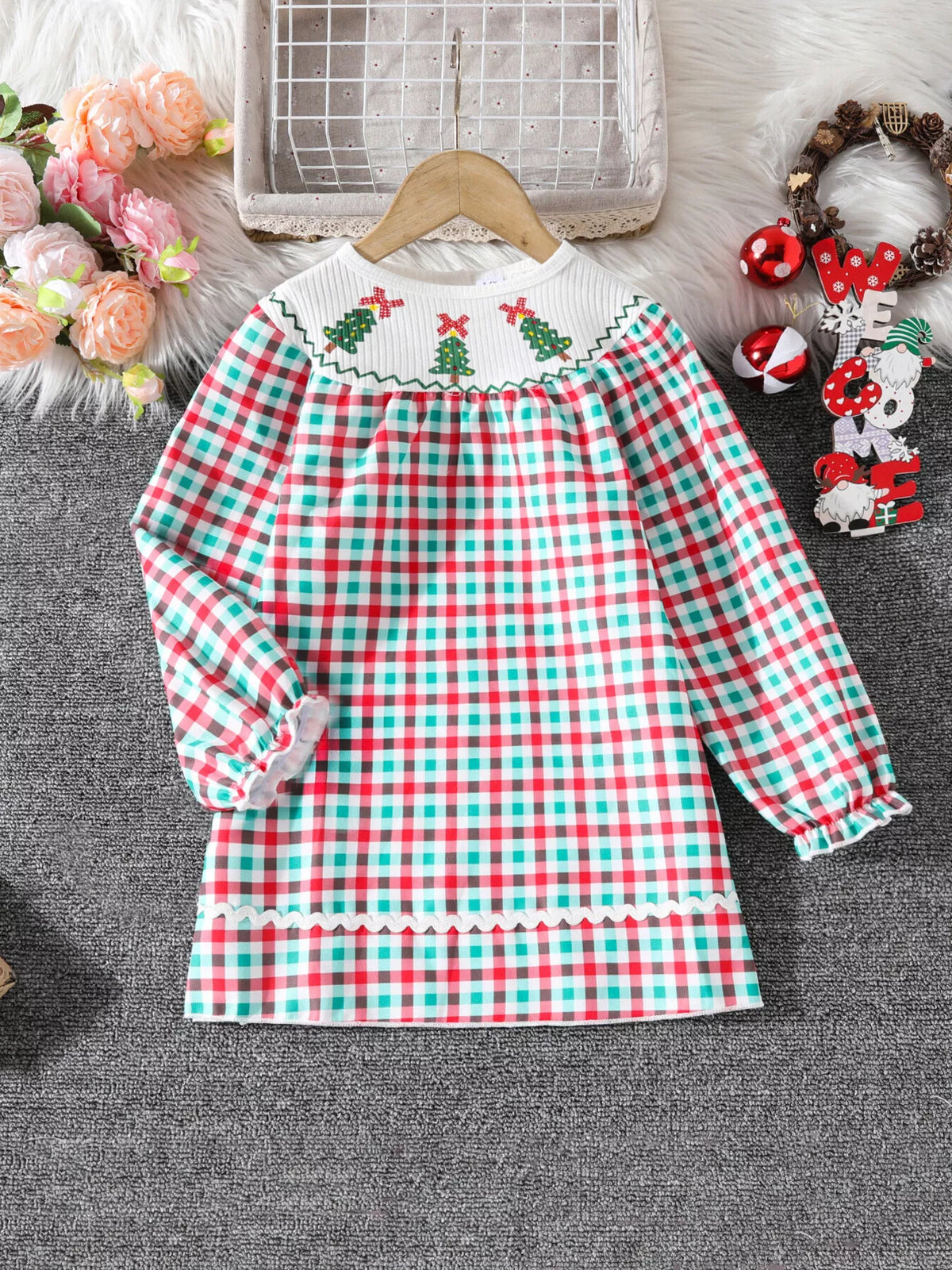 Festive girls' multicolor plaid dress with embroidered Christmas trees on the smocked collar and ruffled cuffs.