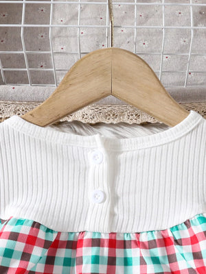 Baby girls' dress with white ribbed top and multicolor plaid skirt, featuring button detail.
