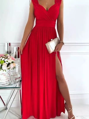 Scarlet maxi dress with lace neckline and high slit, styled with a clutch.
